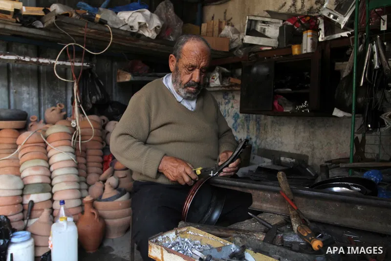 A Palestinian man works at his work-shop in a market in Rafah in the southern Gaza strip, April 19, 2016. Photo by Abed Rahim Khatib
