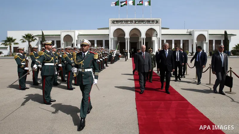 Algerian Prime Minister Abdelmalek Sellal walks alongside with Palestinian Prime Minister Rami Hamdallah before leaving Algerian Houari Boumediene International Airport in the capital Algiers on April 19, 2016. Photo by...
