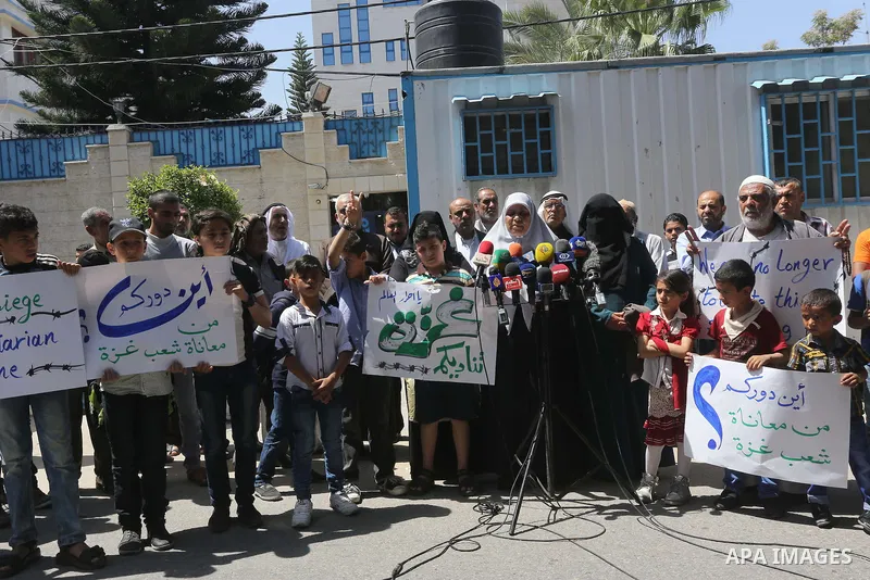 Palestinian owners of houses which were destroyed during the recent Israeli war, take part in a protest, in front of high commissioner for human rights headquarters, in Gaza City on April 20, 2016. Israeli occupation pri...
