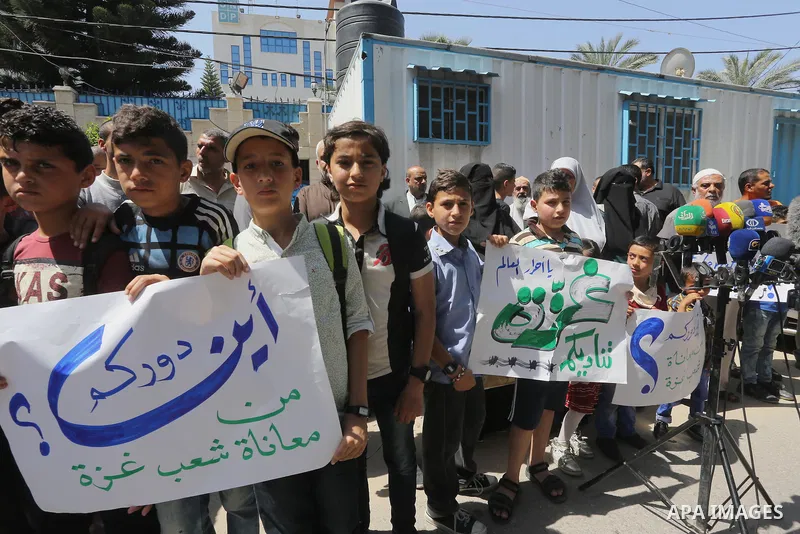 Palestinian owners of houses which were destroyed during the recent Israeli war, take part in a protest, in front of high commissioner for human rights headquarters, in Gaza City on April 20, 2016. Israeli occupation pri...