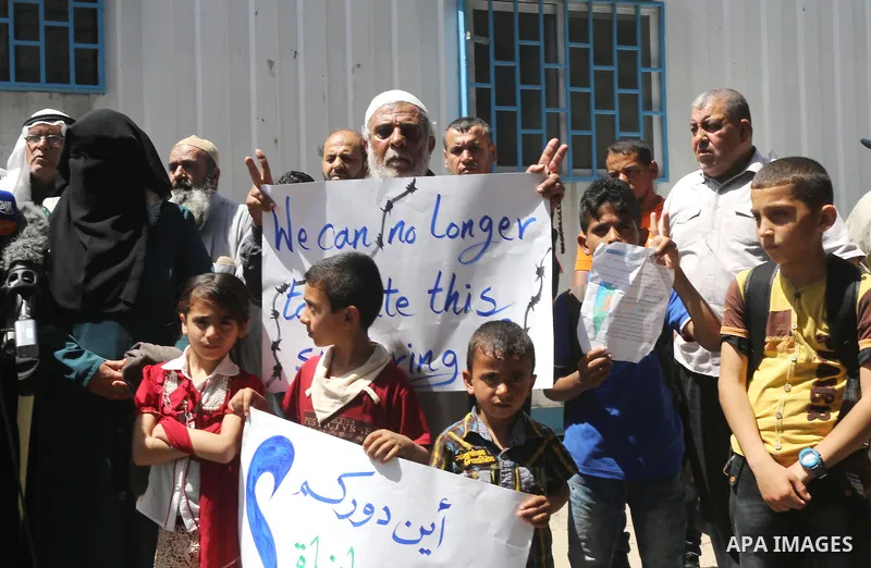 Palestinian owners of houses which were destroyed during the recent Israeli war, take part in a protest, in front of high commissioner for human rights headquarters, in Gaza City on April 20, 2016. Israeli occupation pri...