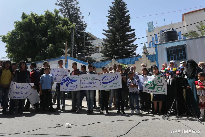 Palestinian owners of houses which were destroyed during the recent Israeli war, take part in a protest, in front of high commissioner for human rights headquarters, in Gaza City on April 20, 2016. Israeli occupation pri...