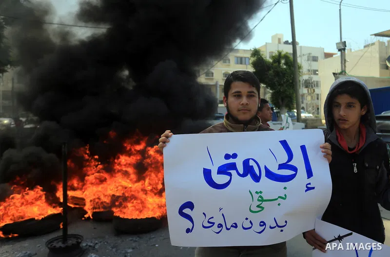 Palestinian owners of houses which were destroyed during the recent Israeli war, burn tires during a protest, in front of high commissioner for human rights headquarters, in Gaza City on April 20, 2016. Israeli occupatio...