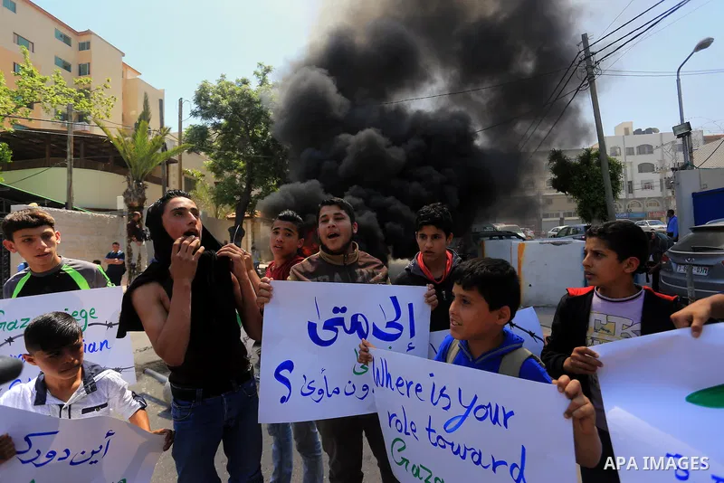 Palestinian owners of houses which were destroyed during the recent Israeli war, burn tires during a protest, in front of high commissioner for human rights headquarters, in Gaza City on April 20, 2016. Israeli occupatio...