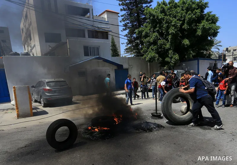 Palestinian owners of houses which were destroyed during the recent Israeli war, burn tires during a protest, in front of high commissioner for human rights headquarters, in Gaza City on April 20, 2016. Israeli occupatio...