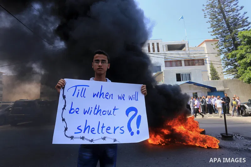 Palestinian owners of houses which were destroyed during the recent Israeli war, burn tires during a protest, in front of high commissioner for human rights headquarters, in Gaza City on April 20, 2016. Israeli occupatio...