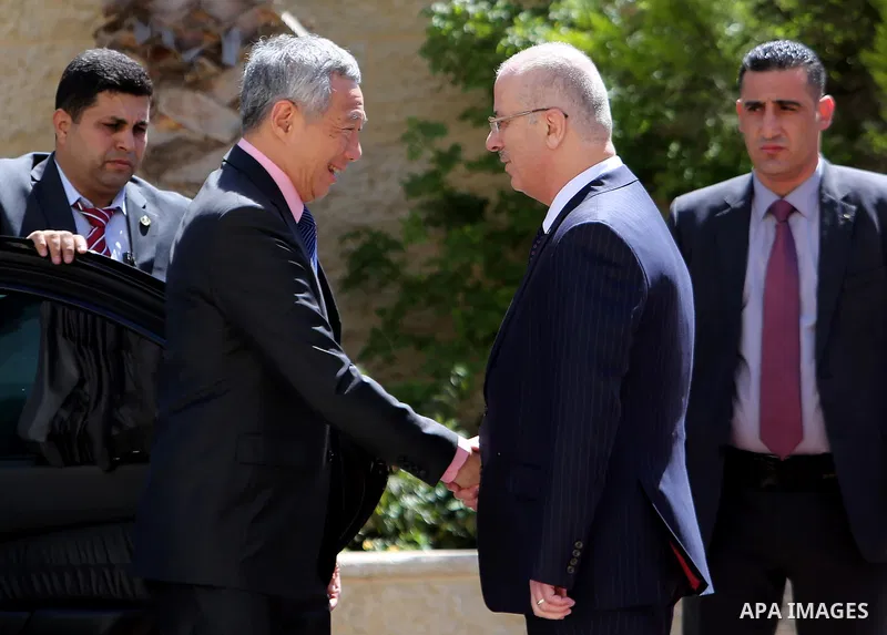 Palestinian Prime Minister Rami Hamdallah and Singapore's Prime Minister Lee Hsien Loong review the honour guard upon Lee's arrival in the West Bank city of Ramallah, April 20, 2016. Photo by Prime Minister Office