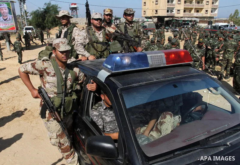 Members of Palestinian security forces loyal to Hamas ride a pickup truck as they are deployed to maintain security on the border of southern Gaza Strip with Egypt, April 21, 2016. Hamas began deploying additional forces...