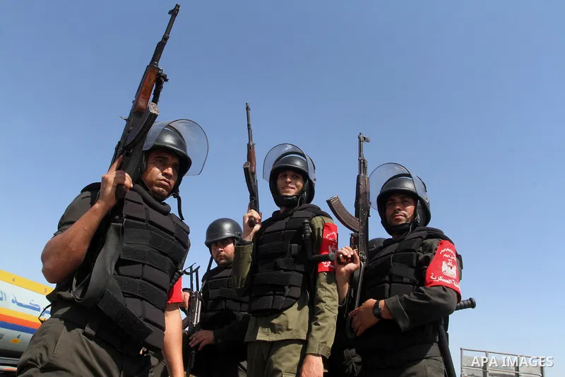 Members of Palestinian security forces loyal to Hamas ride a pickup truck as they are deployed to maintain security on the border of southern Gaza Strip with Egypt, April 21, 2016. Hamas began deploying additional forces...