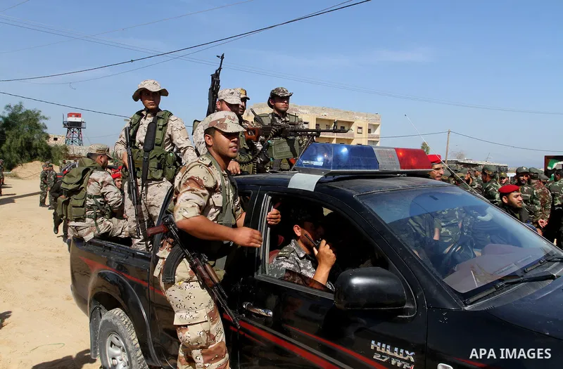Members of Palestinian security forces loyal to Hamas ride a pickup truck as they are deployed to maintain security on the border of southern Gaza Strip with Egypt, April 21, 2016. Hamas began deploying additional forces...