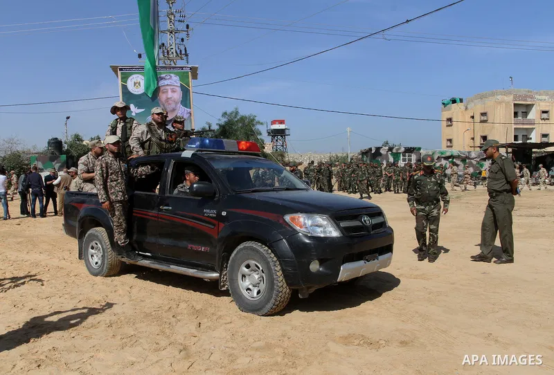 Members of Palestinian security forces loyal to Hamas ride a pickup truck as they are deployed to maintain security on the border of southern Gaza Strip with Egypt, April 21, 2016. Hamas began deploying additional forces...