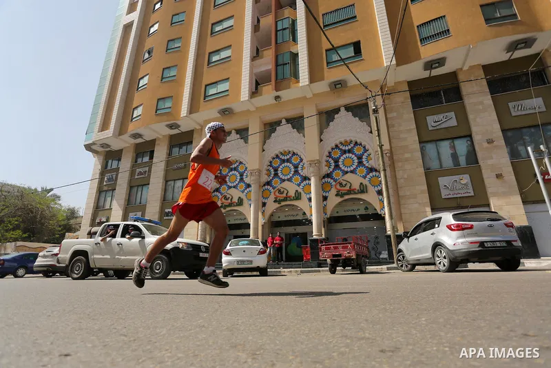 Palestinian youths take part in a marathon organized by Hamas and Fateh movement to mark Palestinian Prisoner Day, in Gaza city, on April 23, 2016. Photo by Mohammed Asad