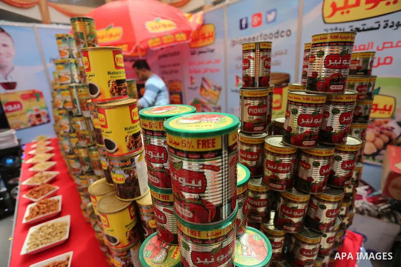 Palestinians attend exhibition for national products at Islamic University, in Gaza city, on April 24, 2016. Photo by Mohammed Asad