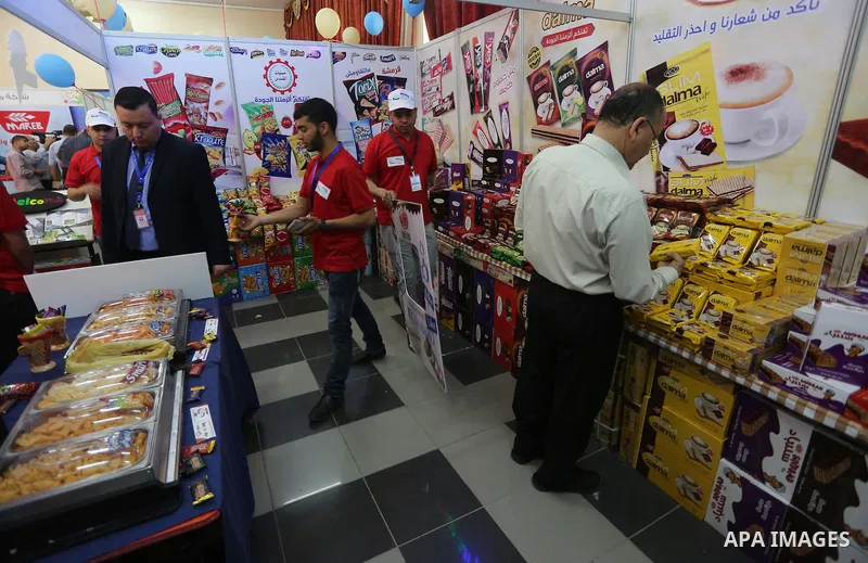 Palestinians attend exhibition for national products at Islamic University, in Gaza city, on April 24, 2016. Photo by Mohammed Asad