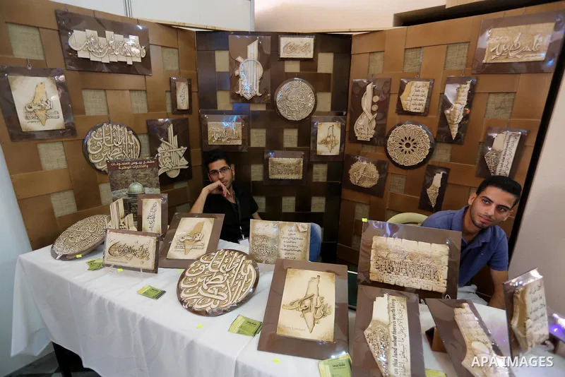 Palestinians attend exhibition for national products at Islamic University, in Gaza city, on April 24, 2016. Photo by Mohammed Asad