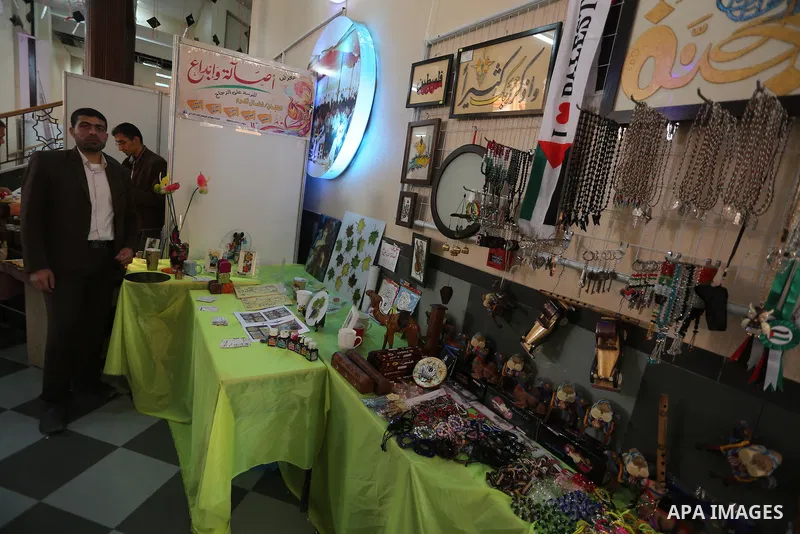 Palestinians attend exhibition for national products at Islamic University, in Gaza city, on April 24, 2016. Photo by Mohammed Asad