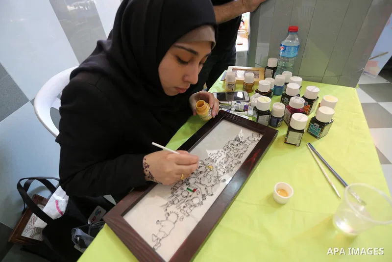 Palestinians attend exhibition for national products at Islamic University, in Gaza city, on April 24, 2016. Photo by Mohammed Asad