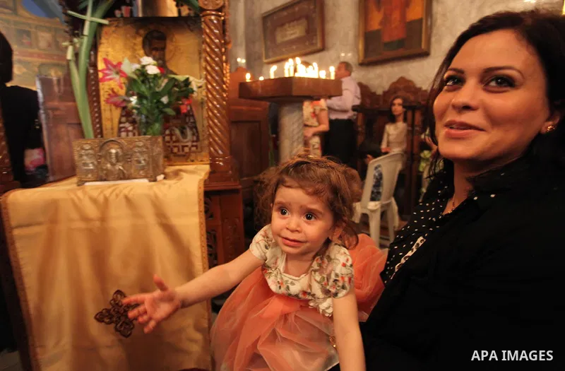 Palestinian Christians take part in the Greek Orthodox Christian Palm Sunday celebrations at St.Porphyrios Church in Gaza City, on April 24, 2016. Palm Sunday marks the triumphant return of Jesus Christ to Jerusalem when...
