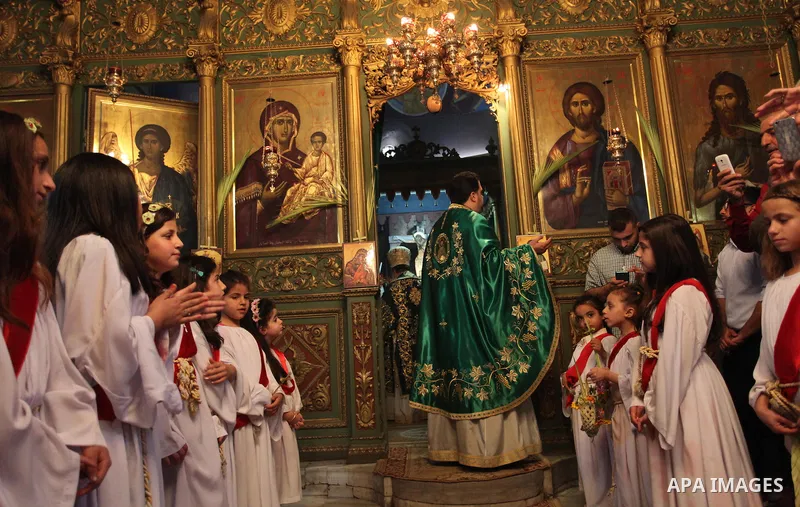 Palestinian Christians take part in the Greek Orthodox Christian Palm Sunday celebrations at St.Porphyrios Church in Gaza City, on April 24, 2016. Palm Sunday marks the triumphant return of Jesus Christ to Jerusalem when...