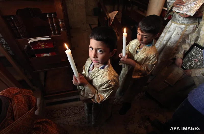 Palestinian Christians take part in the Greek Orthodox Christian Palm Sunday celebrations at St.Porphyrios Church in Gaza City, on April 24, 2016. Palm Sunday marks the triumphant return of Jesus Christ to Jerusalem when...