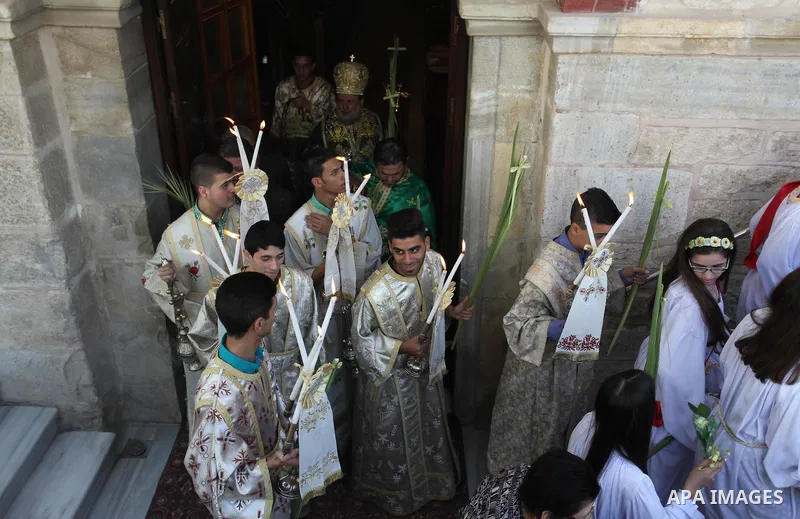 Palestinian Christians take part in the Greek Orthodox Christian Palm Sunday celebrations at St.Porphyrios Church in Gaza City, on April 24, 2016. Palm Sunday marks the triumphant return of Jesus Christ to Jerusalem when...