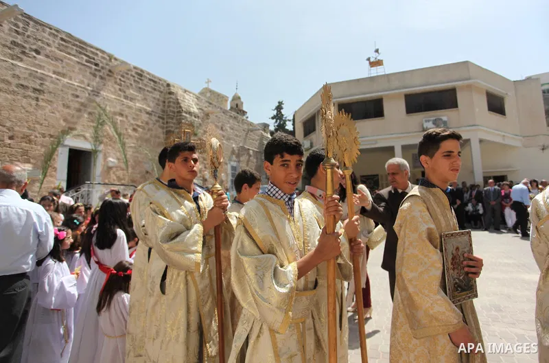 Palestinian Christians take part in the Greek Orthodox Christian Palm Sunday celebrations at St.Porphyrios Church in Gaza City, on April 24, 2016. Palm Sunday marks the triumphant return of Jesus Christ to Jerusalem when...