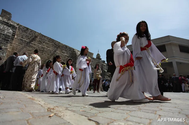 Palestinian Christians take part in the Greek Orthodox Christian Palm Sunday celebrations at St.Porphyrios Church in Gaza City, on April 24, 2016. Palm Sunday marks the triumphant return of Jesus Christ to Jerusalem when...