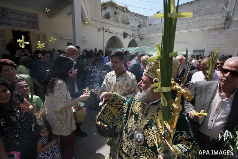 Palestinian Christians take part in the Greek Orthodox Christian Palm Sunday celebrations at St.Porphyrios Church in Gaza City, on April 24, 2016. Palm Sunday marks the triumphant return of Jesus Christ to Jerusalem when...