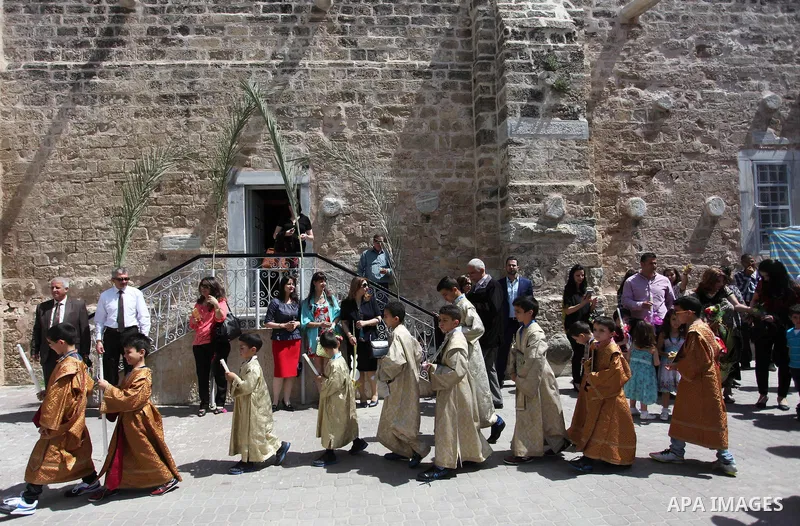 Palestinian Christians take part in the Greek Orthodox Christian Palm Sunday celebrations at St.Porphyrios Church in Gaza City, on April 24, 2016. Palm Sunday marks the triumphant return of Jesus Christ to Jerusalem when...