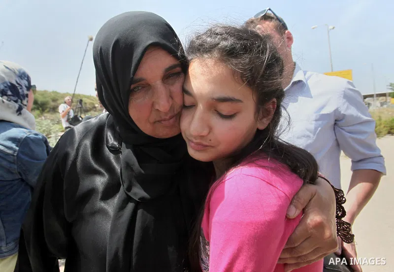 Released Palestinian prisoner Deema Al-Wawi, 12, who was detained by Israeli authorities for around two and half months, hugs her mother following her release near the West Bank city of Tulkarm April 24, 2016. Photo by N...