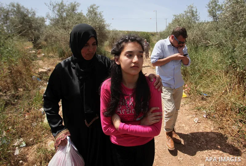 Released Palestinian prisoner Deema Al-Wawi, 12, who was detained by Israeli authorities for around two and half months, hugs her mother following her release near the West Bank city of Tulkarm April 24, 2016. Photo by N...