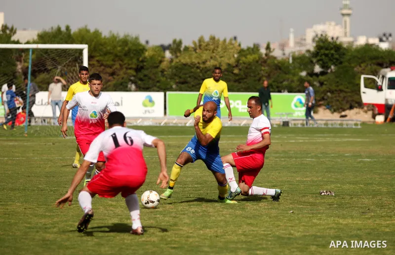 Palestinian Shabab Jabalia players and Shabab Khan Younis players compete during the final match of the Gaza Cup at Yarmuk stadium in Gaza City, on April 24, 2016. Photo by Ashraf Amra