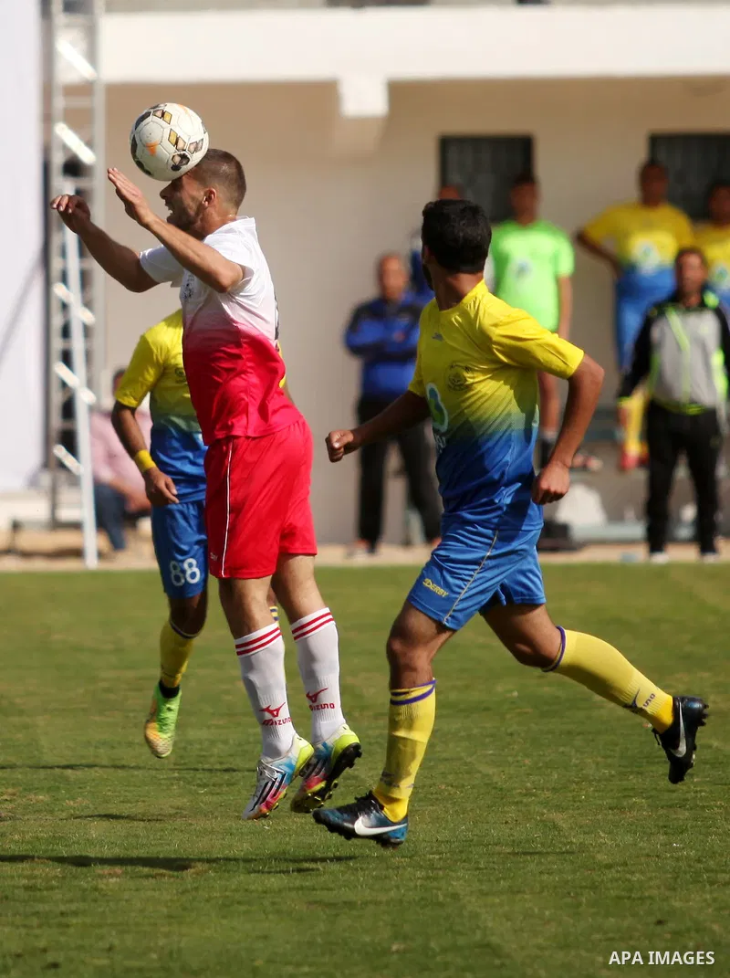 Palestinian Shabab Jabalia players and Shabab Khan Younis players compete during the final match of the Gaza Cup at Yarmuk stadium in Gaza City, on April 24, 2016. Photo by Ashraf Amra