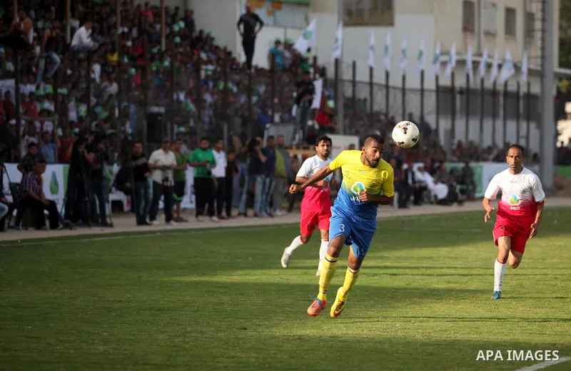Palestinian Shabab Jabalia players and Shabab Khan Younis players compete during the final match of the Gaza Cup at Yarmuk stadium in Gaza City, on April 24, 2016. Photo by Ashraf Amra
