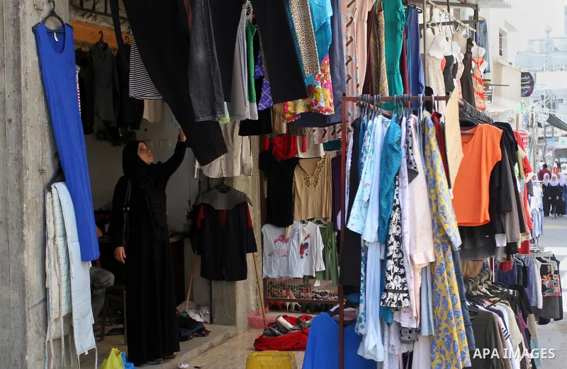 Palestinians looks at second hand clothes at a market in Rafah in the southern Gaza strip, on April 26, 2016. Due to the current economic situation in Gaza Strip, many of the Palestinians resort to meet their needs of us...