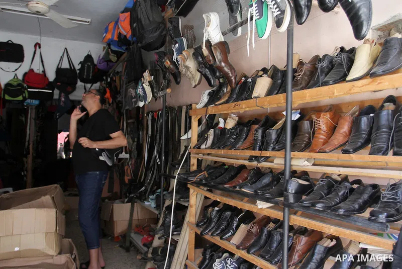 Palestinians looks at second hand clothes at a market in Rafah in the southern Gaza strip, on April 26, 2016. Due to the current economic situation in Gaza Strip, many of the Palestinians resort to meet their needs of us...
