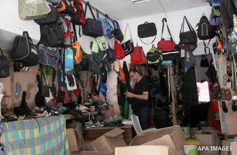 Palestinians looks at second hand clothes at a market in Rafah in the southern Gaza strip, on April 26, 2016. Due to the current economic situation in Gaza Strip, many of the Palestinians resort to meet their needs of us...