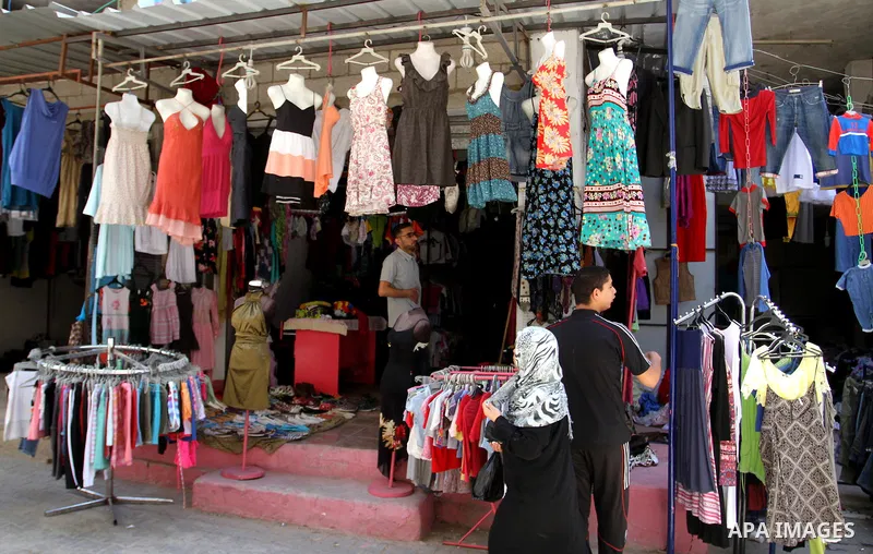 Palestinians looks at second hand clothes at a market in Rafah in the southern Gaza strip, on April 26, 2016. Due to the current economic situation in Gaza Strip, many of the Palestinians resort to meet their needs of us...