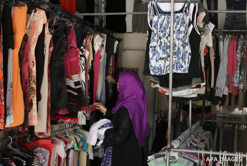 Palestinians looks at second hand clothes at a market in Rafah in the southern Gaza strip, on April 26, 2016. Due to the current economic situation in Gaza Strip, many of the Palestinians resort to meet their needs of us...