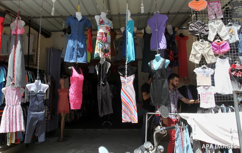 Palestinians looks at second hand clothes at a market in Rafah in the southern Gaza strip, on April 26, 2016. Due to the current economic situation in Gaza Strip, many of the Palestinians resort to meet their needs of us...