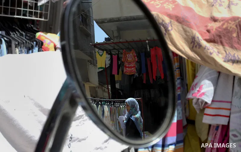 Palestinians looks at second hand clothes at a market in Rafah in the southern Gaza strip, on April 26, 2016. Due to the current economic situation in Gaza Strip, many of the Palestinians resort to meet their needs of us...