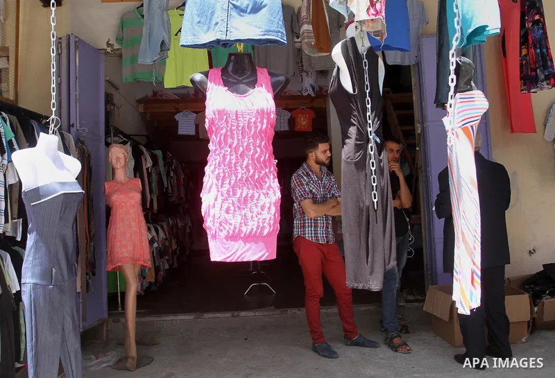 Palestinians looks at second hand clothes at a market in Rafah in the southern Gaza strip, on April 26, 2016. Due to the current economic situation in Gaza Strip, many of the Palestinians resort to meet their needs of us...