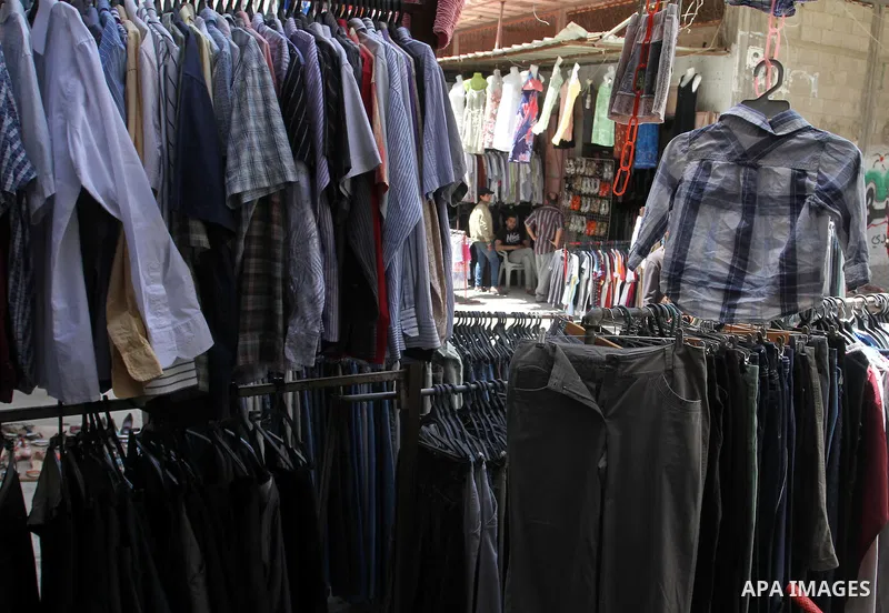 Palestinians looks at second hand clothes at a market in Rafah in the southern Gaza strip, on April 26, 2016. Due to the current economic situation in Gaza Strip, many of the Palestinians resort to meet their needs of us...