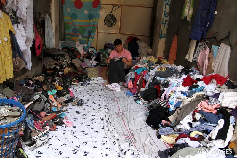 Palestinians looks at second hand clothes at a market in Rafah in the southern Gaza strip, on April 26, 2016. Due to the current economic situation in Gaza Strip, many of the Palestinians resort to meet their needs of us...