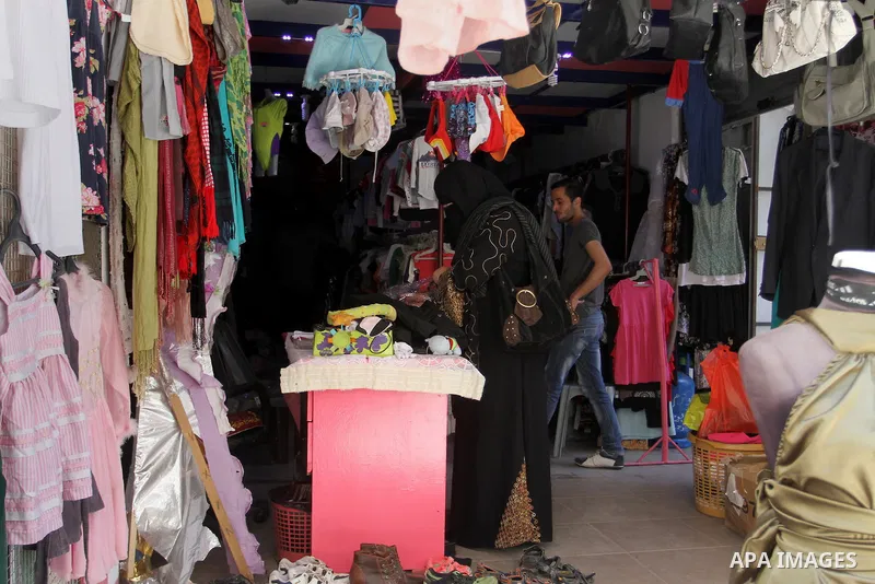 Palestinians looks at second hand clothes at a market in Rafah in the southern Gaza strip, on April 26, 2016. Due to the current economic situation in Gaza Strip, many of the Palestinians resort to meet their needs of us...