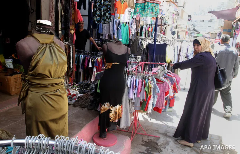 Palestinians looks at second hand clothes at a market in Rafah in the southern Gaza strip, on April 26, 2016. Due to the current economic situation in Gaza Strip, many of the Palestinians resort to meet their needs of us...