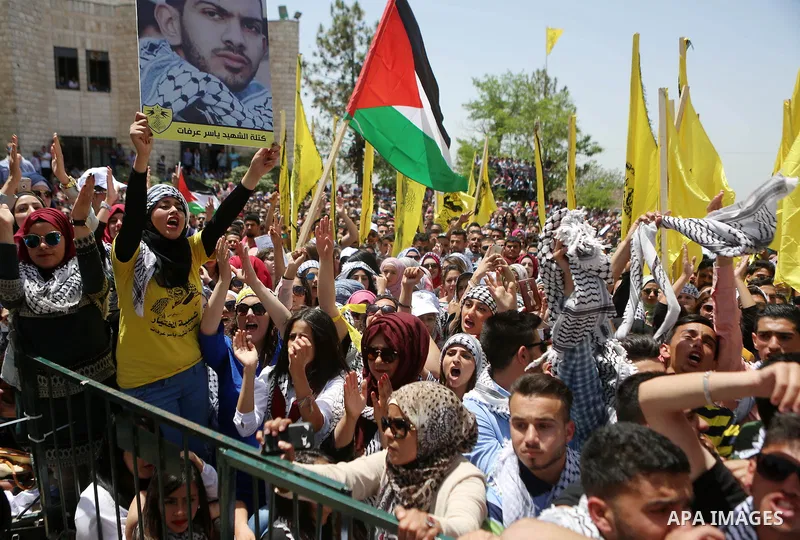 Palestinian students supporting Fatah movement take part in a rally during an election campaign for the student council at the Birzeit University in the West Bank city of Ramallah April 26, 2016. Photo by Shadi Hatem