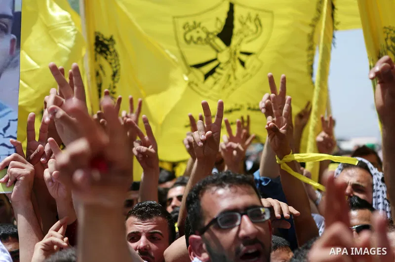 Palestinian students supporting Fatah movement take part in a rally during an election campaign for the student council at the Birzeit University in the West Bank city of Ramallah April 26, 2016. Photo by Shadi Hatem