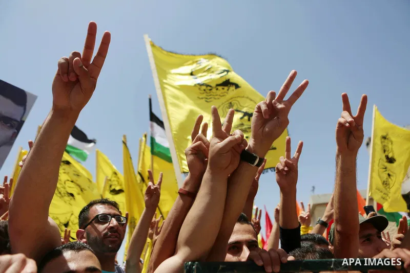 Palestinian students supporting Fatah movement take part in a rally during an election campaign for the student council at the Birzeit University in the West Bank city of Ramallah April 26, 2016. Photo by Shadi Hatem