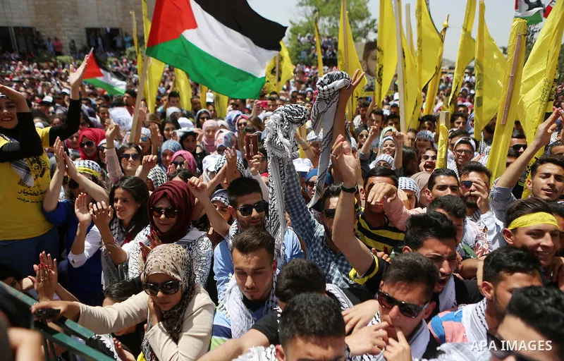 Palestinian students supporting Fatah movement take part in a rally during an election campaign for the student council at the Birzeit University in the West Bank city of Ramallah April 26, 2016. Photo by Shadi Hatem